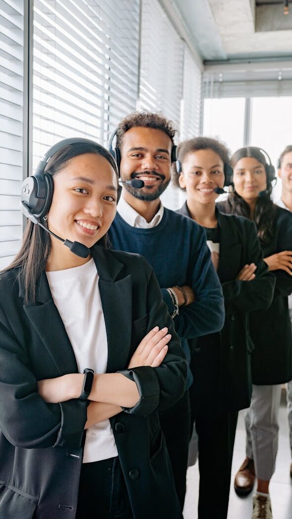 People Standing Near the Window with Blinds